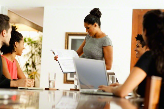 São Paulo, Brazil --- Woman making presentation at business meeting, Sao Paulo, Brazil --- Image by © JAG Images/Corbis